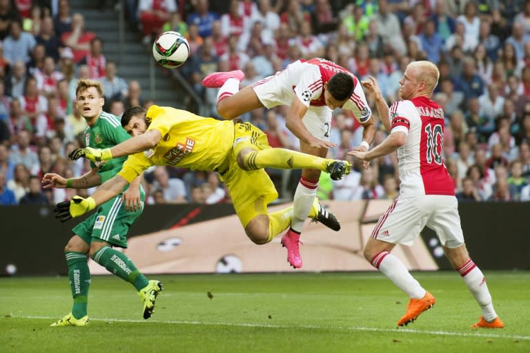 Ajax Amsterdam's Dutch striker Anwar El Ghazi (2nd-R) challenges Rapid Wien's Slovakian goalkeeper Jan Novota (2nd-L) during the UEFA Champions League third qualifying round football match at the Amsterdam Arena on August 4, 2015