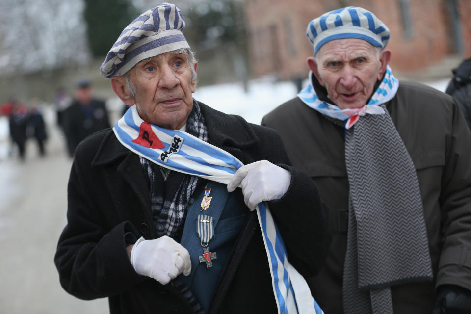 Members of an association of Auschwitz survivors, including one showing a medal given to Polish former concentration camp prisoners, depart after laying wreaths at the execution wall at the former Auschwitz I concentration camp on January 27, 2015 in Oswiecim, Poland. International heads of state, dignitaries and over 300 Auschwitz survivors are attending the commemorations for the 70th anniversary of the liberation of Auschwitz by Soviet troops on 27th January, 1945. Auschwitz was among the most notorious of the concentration camps run by the Nazis during WWII and whilst it is impossible to put an exact figure on the death toll it is alleged that over a million people lost their lives in the camp, the majority of whom were Jewish.