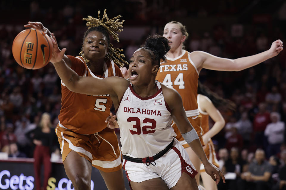 Texas forward DeYona Gaston (5) and Oklahoma forward Sahara Williams (32) fight for the ball while Texas forward Taylor Jones (44) looks on during the second half of an NCAA college basketball game Wednesday, Feb. 28, 2024, in Norman, Okla. (AP Photo/Garett Fisbeck)