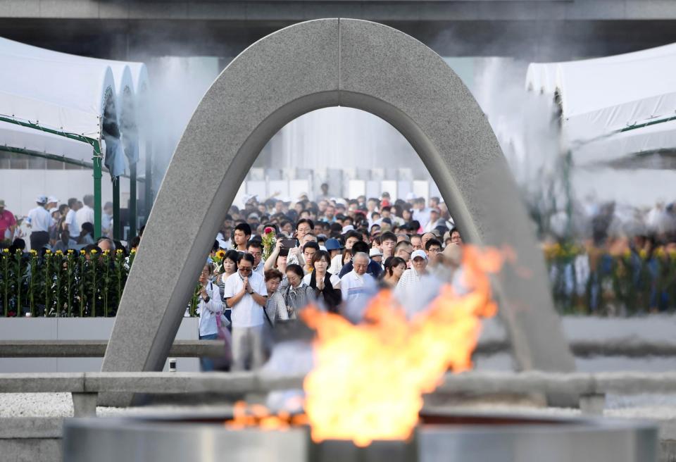 <p>People pray for atomic bomb victims in front of the cenotaph for the victims of the 1945 atomic bombing, at Peace Memorial Park in Hiroshima, western Japan, August 6, 2017, on the 72nd anniversary of the atomic bombing of the city. (Photo: Kyodo via Reuters) </p>