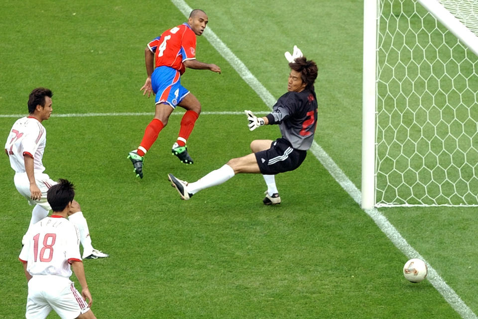 FILE - Costa Rica's Mauricio Wright, top center, scores past China's goalkeeper Jiang Jin during their 2002 World Cup Group C soccer match at the Gwangju World Cup stadium in Gwangju, South Korea, Tuesday June 4, 2002 as China's Li Xiaopeng, bottom left, and Xu Yunlong look on. China is missing out on the World Cup again despite spending millions — probably billions — to develop the game, a reported priority of Xi Jinping, the all-powerful general secretary of the Chinese Communist Party. (AP Photo/Lawrence Jackson, File)