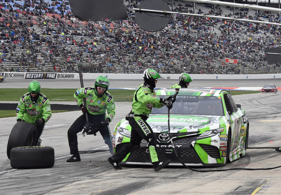 Kyle Busch (18) has a tire change and adjustments made during a stop late in a NASCAR Cup series auto race in Fort Worth, Texas, Sunday, April 8, 2018. (AP Photo/Larry Papke)