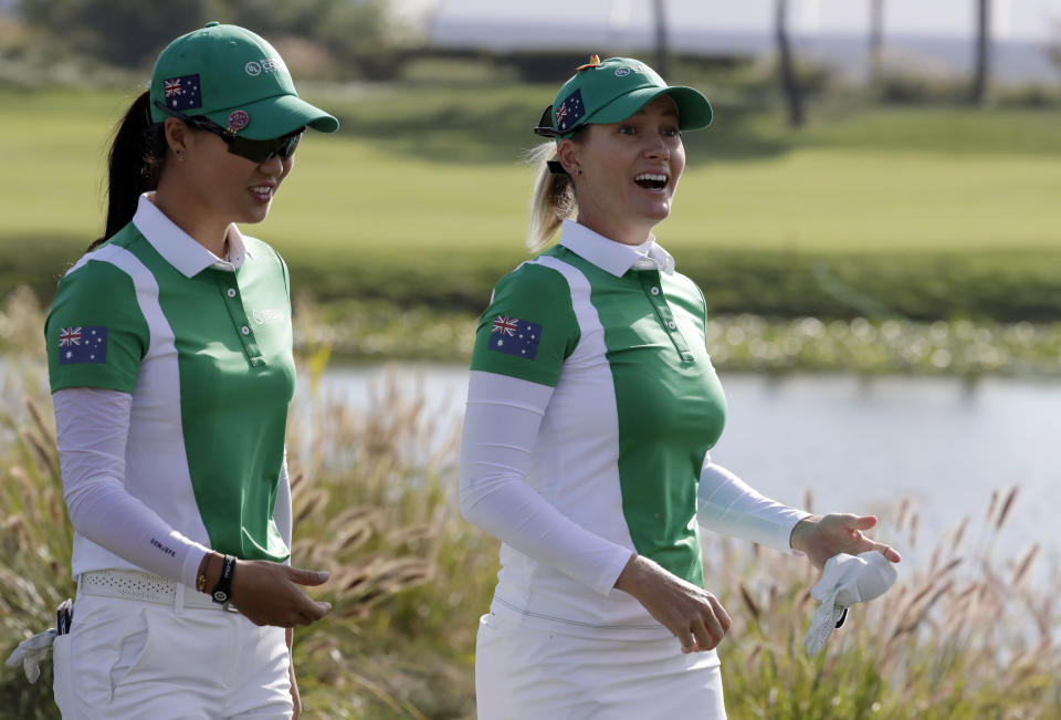 Minjee Lee of Australia, left, and her teammate Sarah Jane Smith, right, walk on the first hole during the first round of the UL International Crown golf tournament at the Jack Nicklaus Golf Club Korea, in Incheon, South Korea, Thursday, Oct. 4, 2018. (AP Photo/Lee Jin-man)