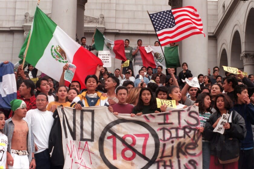 ME.Walk.@@#5.1102.BC/jñññStudents from Belmont High wave flags and yell from steps of City Hall after they walked out of school and marched through downtown to protest Prop 187 .