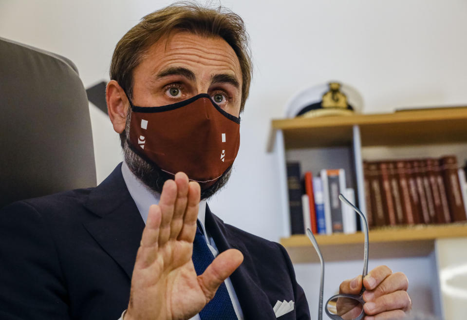 Lawyer Roberto De Vita, representing WHO's deputy director General Ranieri Guerra, speaks during an interview with The Associated Press at his law firm in Rome, Monday, May 10, 2021. A top World Health Organization official has strongly denied making false statements to Italian prosecutors about a spiked U.N. report into Italy’s coronavirus response, doubling down on his assertions in court documents obtained by The Associated Press. Dr. Ranieri Guerra, a WHO special adviser, outlined his position in a 40-page response, with a 495-page annex, to prosecutors who placed him under investigation last month for having allegedly made false statements to them when he voluntarily went to be questioned Nov. 5. (AP Photo/Domenico Stinellis)