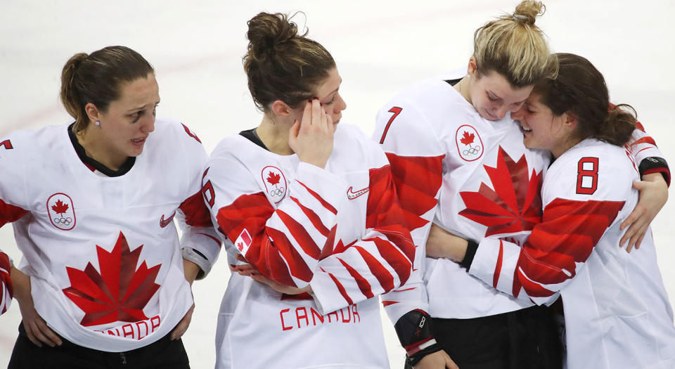 Lauriane Rougeau, and Rebecca Johnston look on as Laura Stacey consoles Laura Fortino. (Steve Russell/Toronto Star via Getty Images)