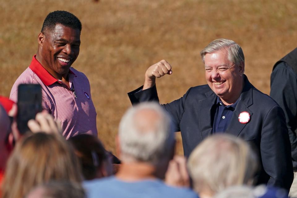 Lindsey Graham, right, campaigning with Herschel Walker (AP)