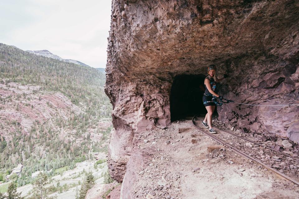 Climbing through a railway tunnel on Gold Mt. Expedition Ferrata