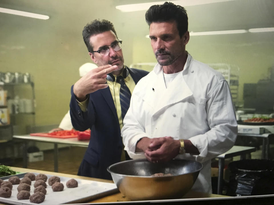 This image released by Universal Pictures shows writer-director James DeMonaco, left, with actors Frank Grillo during the filming of "This is the Night," available on video-on-demand. (KC Bailey/Universal Pictures/Blumhouse via AP)