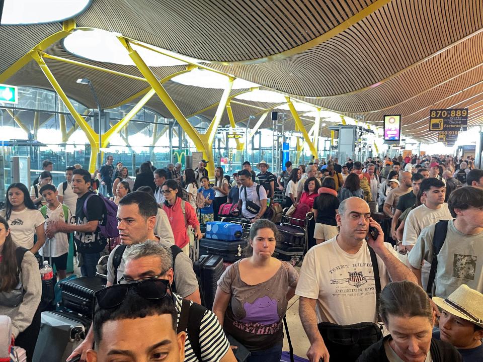 A crowd of people waiting at an airport.