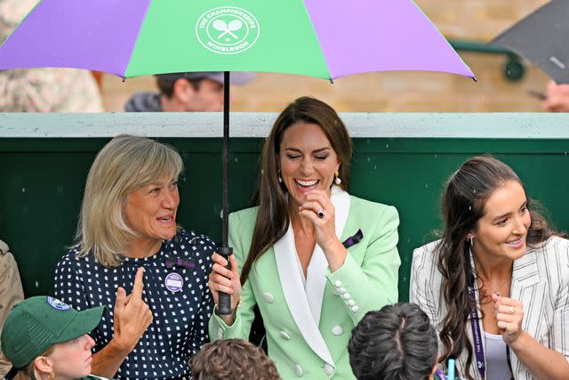 <p>Karwai Tang/WireImage</p> Kate Middleton sheltered under an umbrella as rain stopped play on day two of Wimbledon at the All England Lawn Tennis and Croquet Club on July 04, 2023.