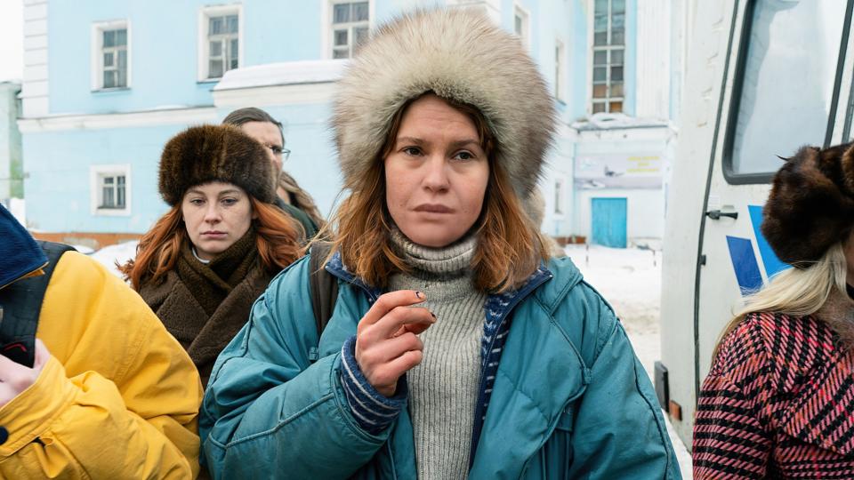 Seidi Haarla stands wearing a coat and a winter hat