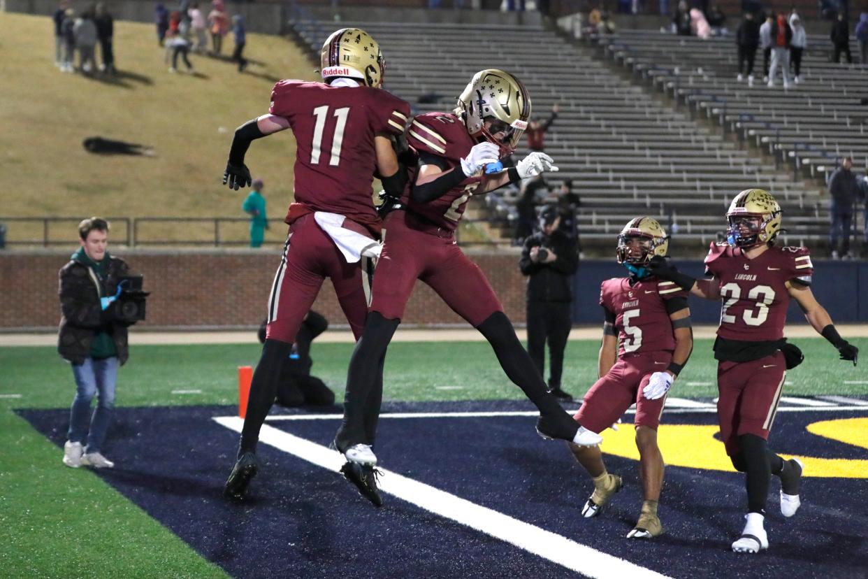 Lincoln Christian's Jack Milligan, left, celebrates with Kylan Schultheis after Milligan caught a touchdown pass during the Class 3A high school football championship game between Heritage Hall and Lincoln Christian at Chad Richison Stadium in Edmond, Okla., Saturday, Dec. 2, 2023. Lincoln Christian won 48-28.