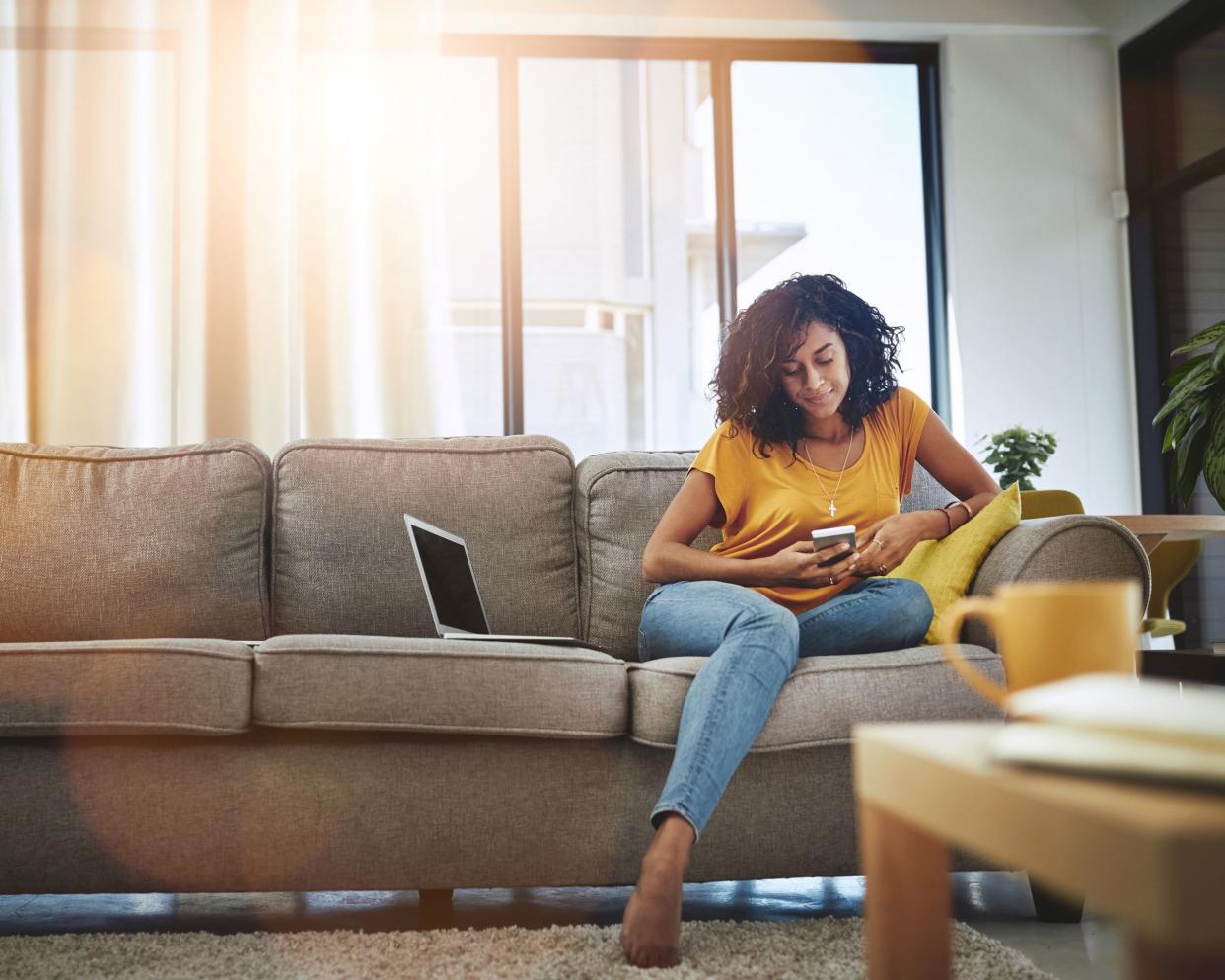 woman house sitting while sitting on couch in living room
