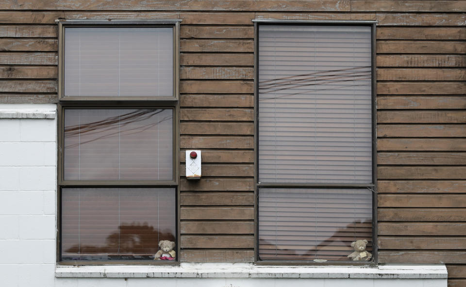 In this Sunday, March 29, 2020, photo, teddy bears sit in windows of a house in Christchurch, New Zealand. New Zealanders are embracing an international movement in which people are placing teddy bears in their windows during coronavirus lockdowns to brighten the mood and give children a game to play by spotting the bears in their neighborhoods. (AP Photo/Mark Baker)