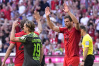 Bayern's Leon Goretzka, right, celebrates after scoring his side's second goal during the German Bundesliga soccer match between Bayern Munich and VfL Wolfsburg at the Allianz Arena in Munich, Germany, Sunday, May 12, 2024. (AP Photo/Matthias Schrader)