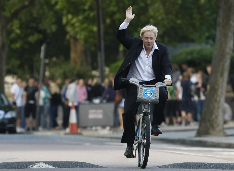 FILE - Boris Johnson, Mayor of London waves to the media as he helps launch a new cycle hire scheme in London Friday, July 30, 2010. British media say Prime Minister Boris Johnson has agreed to resign on Thursday, July 7 2022, ending an unprecedented political crisis over his future. (AP Photo/Alastair Grant, File)