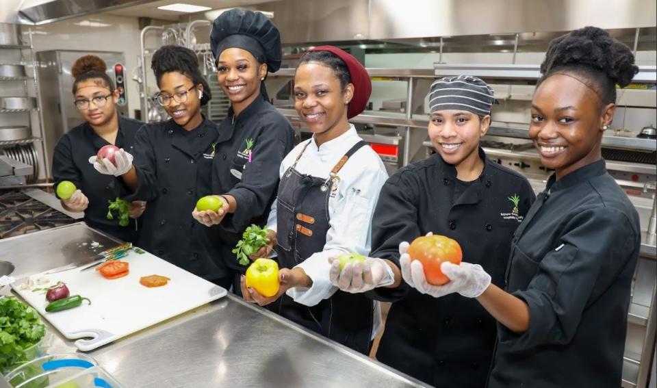 Junior Tyra Dunnaway and several student chefs prepare an array of Mardi Gras-themed dishes during the reopening of Bethune-Cookman University's Cub Paradise Restaurant.