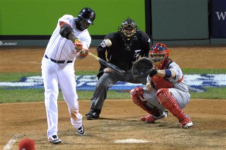 Oct 23, 2013; Boston, MA, USA; Boston Red Sox designated hitter David Ortiz hits a two-run home run against the St. Louis Cardinals during the 7th inning during game one of the MLB baseball World Series at Fenway Park. Bob DeChiara-USA TODAY Sports