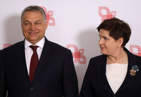 Visegrad Group (V4) member nations' Prime Ministers, Hungary's Viktor Orban and Poland's Beata Szydlo pose for a family photo during a summit in Warsaw, Poland March 28, 2017. Agencja Gazeta/Slawomir Kaminski via REUTERS