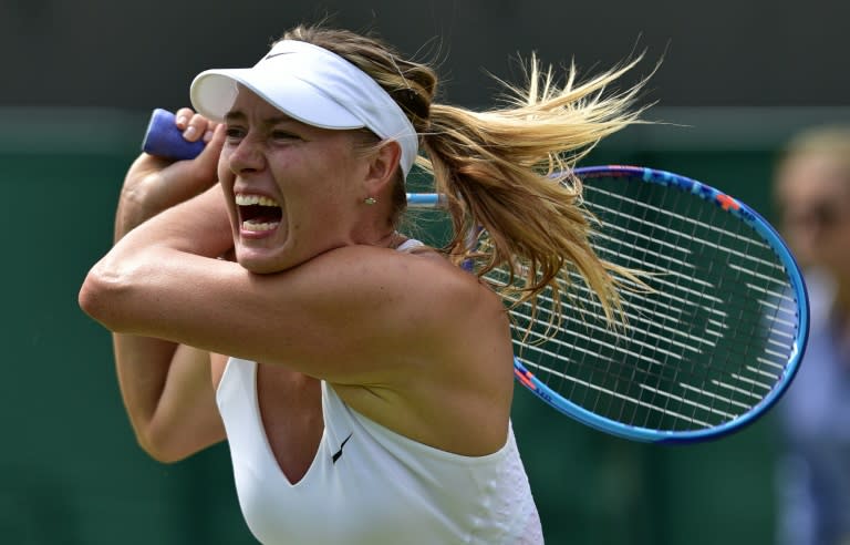 Russia's Maria Sharapova returns to Netherlands' Richel Hogenkamp during their women's singles second round match on day three of the 2015 Wimbledon Championships at The All England Tennis Club in Wimbledon, southwest London, on July 1, 2015