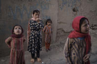 Afghan girls look up and listen as a neighbour describes when two men fell from a U.S. Air Force C-17 taking off from Kabul’s International Airport on Aug. 16 and landed on the rooftop of his house in Kabul, Afghanistan, Friday, Sept. 17, 2021. (AP Photo/Felipe Dana)