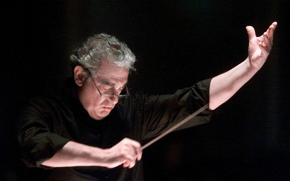 Mr Domingo conducts the orchestra during an opera rehearsal - AP Photo/Richard Drew