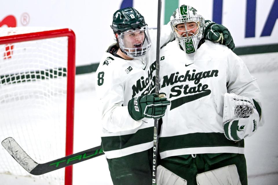 Michigan State's Maxim Strbak, left, and goalie Trey Augustine celebrate after bearing Ohio State in the Big Ten tournament game on Saturday, March 16, 2024, at Munn Arena in East Lansing.