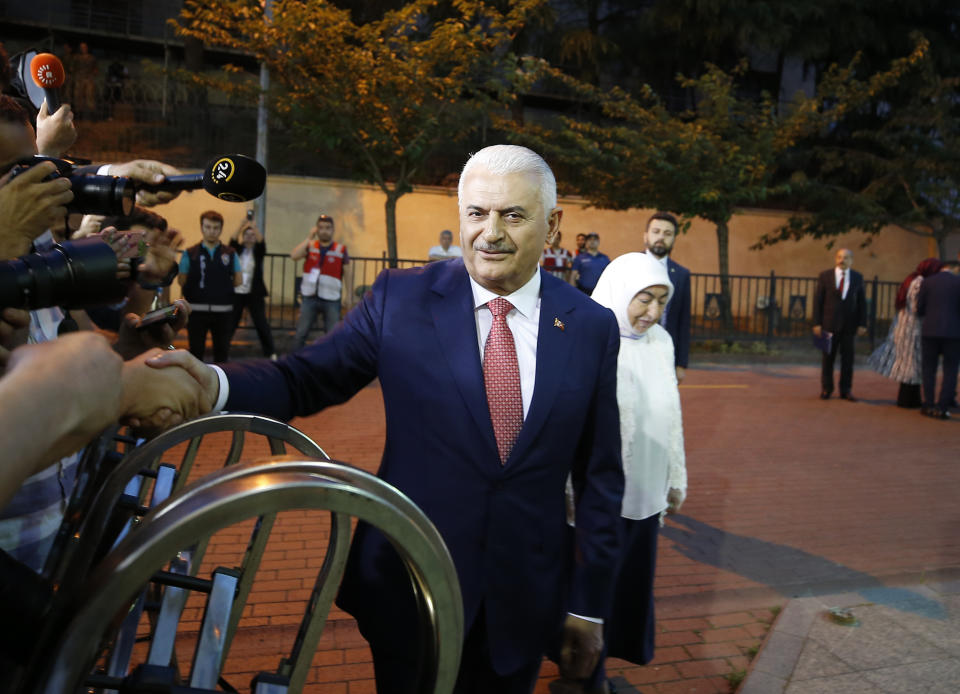 Istanbul's mayoral candidate Binali Yildirim, of Turkey's ruling Justice and Development Party, or AKP, waves as he arrives for a televised debate with Ekrem Imamoglu, candidate of the secular opposition Republican People's Party, or CHP, ahead of June 23 re-run of Istanbul elections, Sunday, June 16, 2019. Televised election debates are uncommon in Turkey. The last one, between AKP leader Recep Tayyip Erdogan and the then-leader of the CHP, took place before a 2002. The AKP has been in power since. (AP Photo/Emrah Gurel)