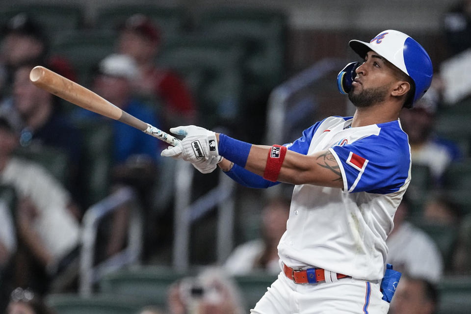 Atlanta Braves' Eddie Rosario hits a two-run home run against the San Francisco Giants during the eighth inning of a baseball game Saturday, Aug. 19, 2023, in Atlanta. (AP Photo/John Bazemore)