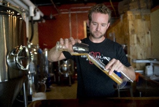 Vero Beach native Alden Bing is shown working at Orchid Island Brewery about the time he opened it with his wife, Valerie, in August 2014.