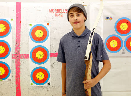 FILE PHOTO: Joshua Lemacks, 14, who has a congenital heart defect, stands for a portrait during archery practice in Richmond, Virginia, U.S. November 18, 2017. REUTERS/Julia Rendleman/File Photo