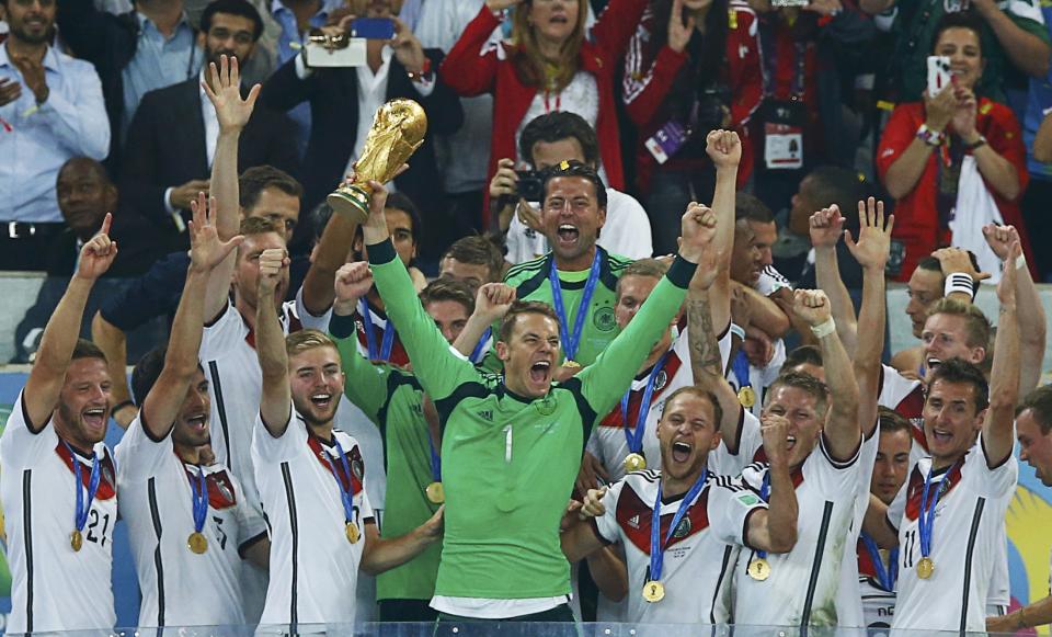 Germany's goalkeeper Neuer lifts the World Cup trophy after the 2014 World Cup final against Argentina at the Maracana stadium in Rio de Janeiro