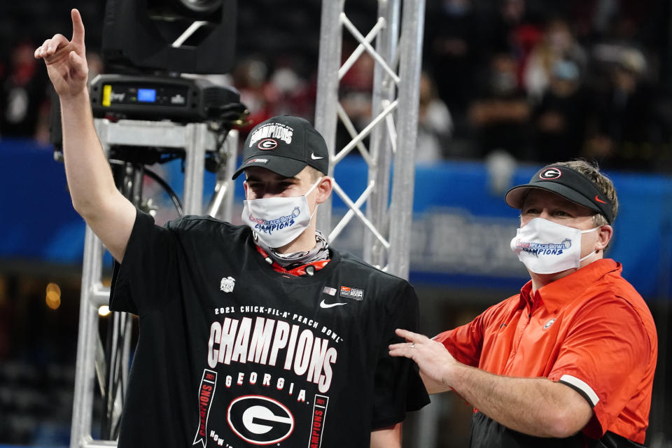 Georgia place kicker Jack Podlesny, offensive player of the game, stands with Georgia head coach Kirby Smart after the Peach Bowl NCAA college football game against Cincinnati, Friday, Jan. 1, 2021, in Atlanta. Georgia won 22-21. (AP Photo/Brynn Anderson)