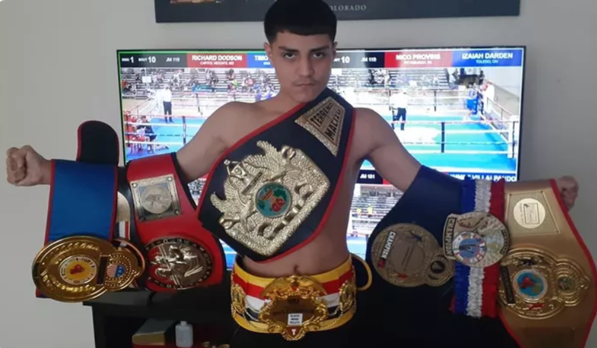 Donovan Garcia poses with his array of boxing belts (GoFundMe)