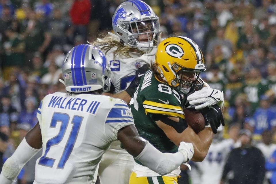 Green Bay Packers' Robert Tonyan catches a touchdown pass between Detroit Lions' Tracy Walker III and Alex Anzalone during the second half of an NFL football game Monday, Sept. 20, 2021, in Green Bay, Wis. (AP Photo/Matt Ludtke)