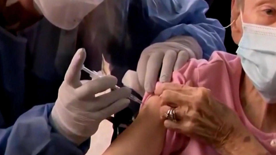 A healthcare worker administers the COVID-19 vaccine.  / Credit: CBS News