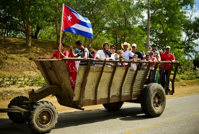 People on trucks head towards the convoy carrying the ashes of Cuban leader Fidel Castro, in Jatibonico