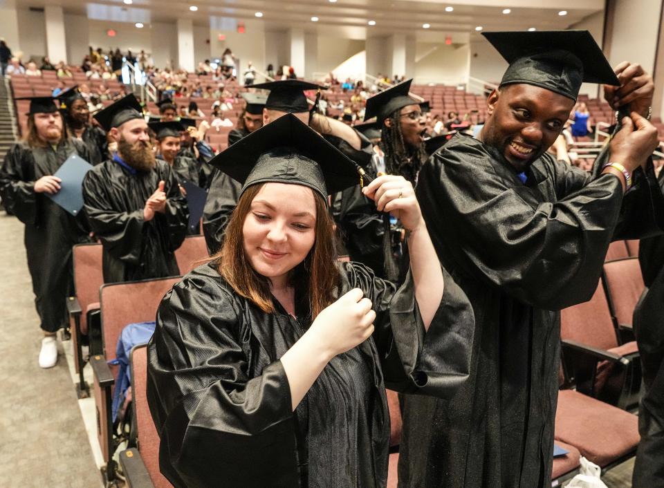 Students turn their tassels at the end of graduation. More than 130 students in JCPS’ Adult Education program received their GEDs on Friday May 17, at a ceremony at the Durrett Auditorium at Male High School.