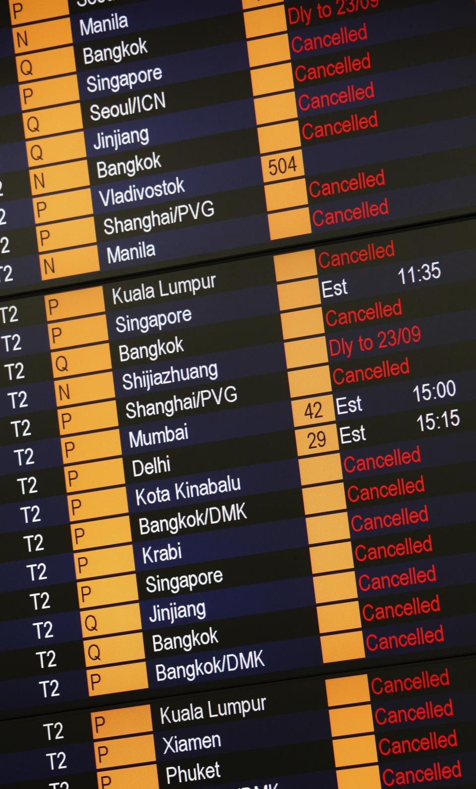 A information board shows flights cancelled in anticipation of typhoon Usagi, at Hong Kong Airport