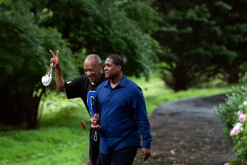 Bill Cosby leaves his home alongside spokesperson Andrew Wyatt in Elkins Park, Pennsylvania, on July 1, 2021. Cosby was released from prison after his 2018 sexual assault conviction was overturned.