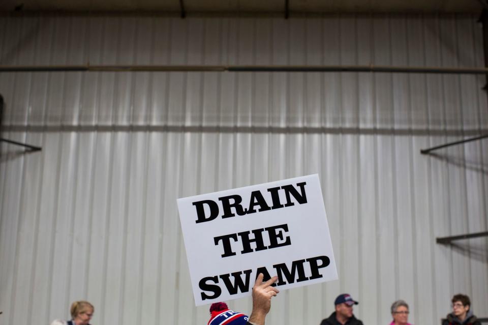 A supporter of then-Republican presidential candidate Donald Trump holds sign during a campaign rally in Ohio. 