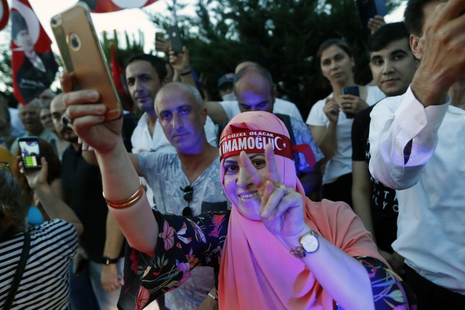 Supporters of newly elected mayor of Istanbul Ekrem Imamoglu celebrate outside the Republican People's Party, CHP, offices in Istanbul, Sunday, June 23, 2019. Turkish President Recep Tayyip Erdogan has congratulated the opposition candidate who won a repeat mayoral election in Istanbul and defeated Erdogan's candidate for the second time. (AP Photo/Lefteris Pitarakis)