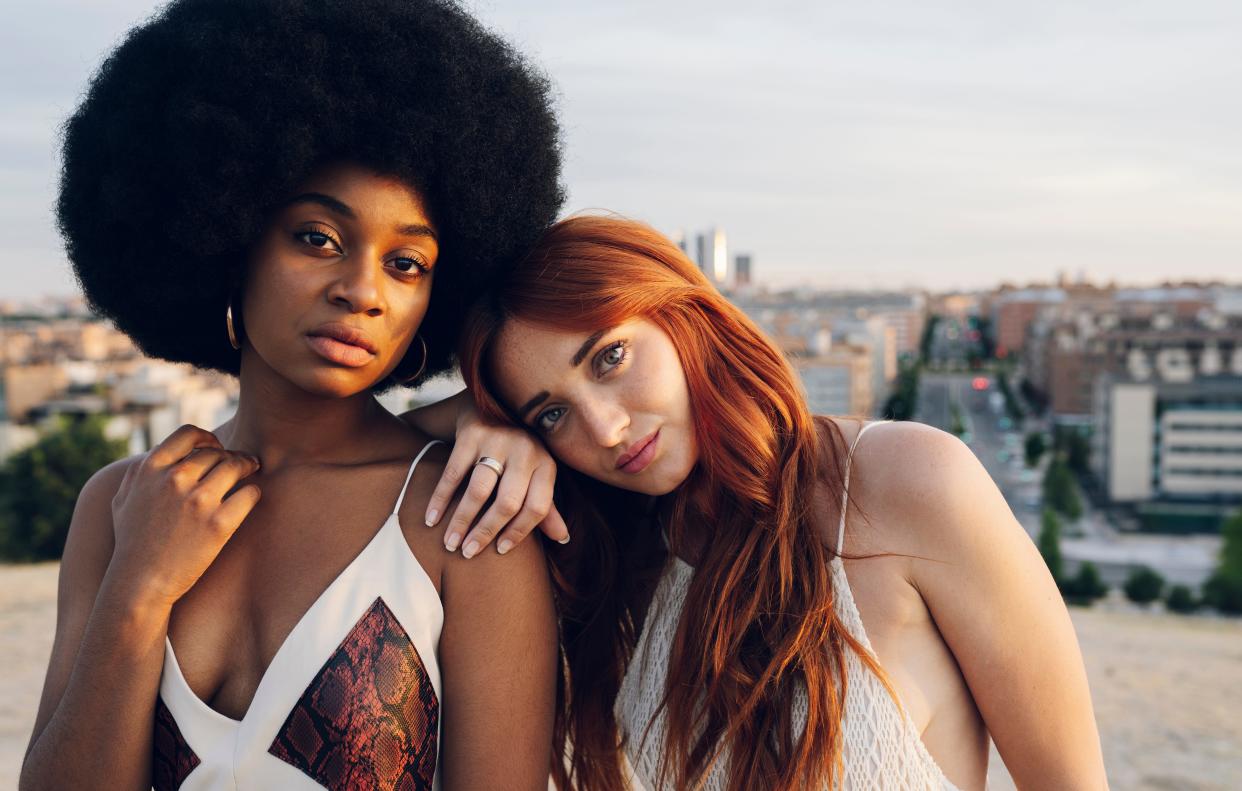 Two female friends on a rooftop