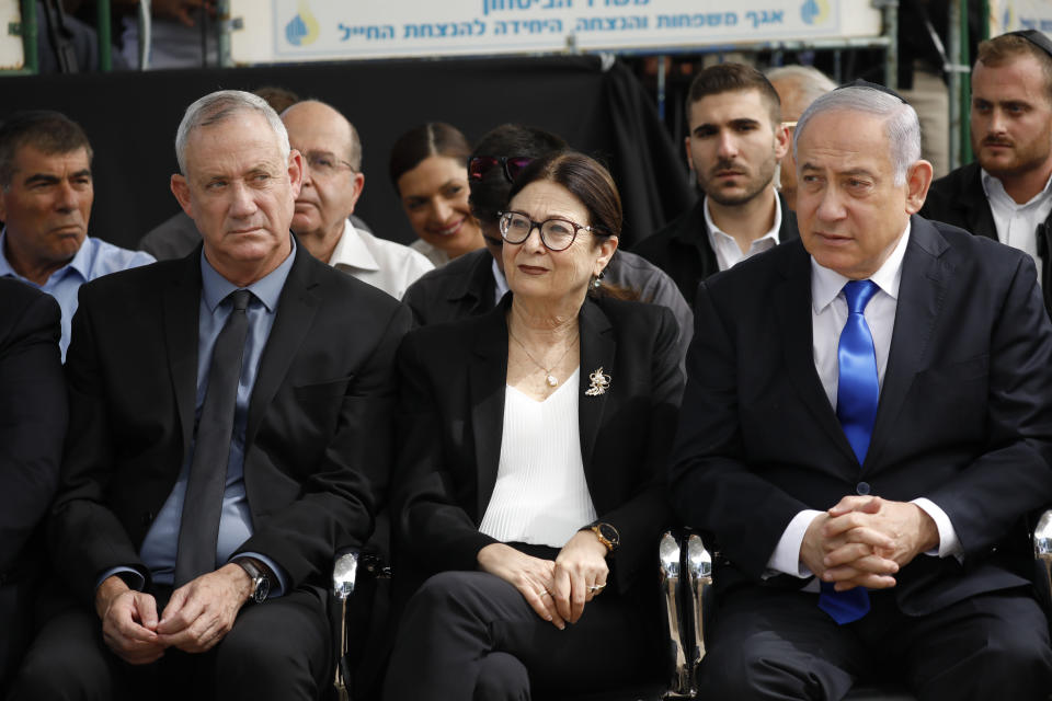 In this Thursday, Sept. 19, 2019 file photo, Blue and White party leader Benny Gantz, left, Esther Hayut, the Chief Justice of the Supreme Court of Israel, and Prime Minister Benjamin Netanyahu attend a memorial service for former President Shimon Peres in Jerusalem. On Sunday, Sept. 22, 2019, Israeli President Reuven Rivlin is starting his two-day consultations with representatives of all elected parties to hear their recommendations for prime minister before he selects his candidate, kicking off the complicated process of forming a new government after a deadlocked repeat election. (AP Photo/Ariel Schalit, File)