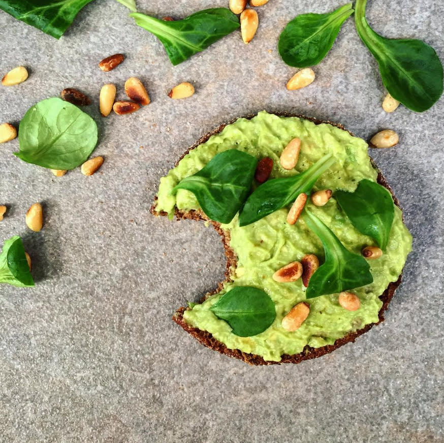 <p>Smashed avocado on rye bread with salad leaves and pine nuts [Photo: Instagram/carmienutri] </p>