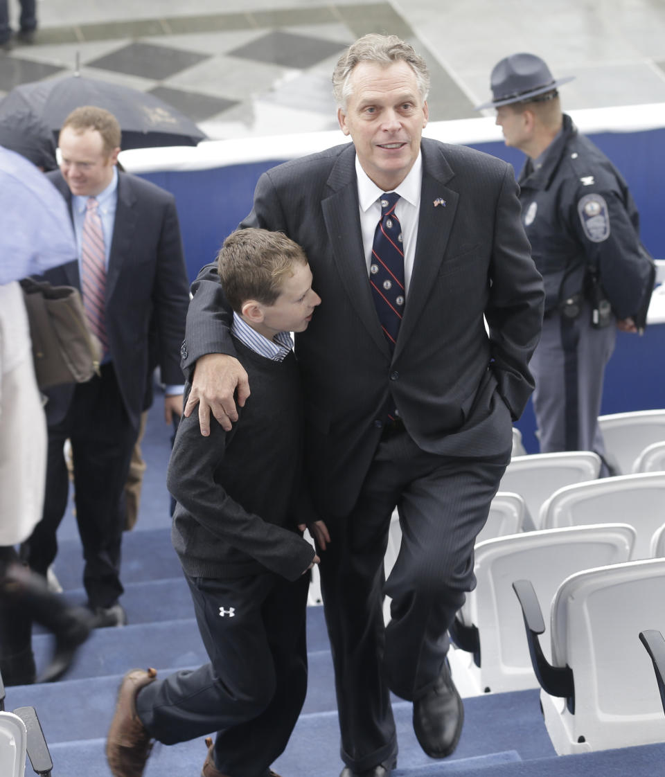 Virginia Gov-elect, Terry McAuliffe and his son, Peter, 11, walk up the steps of the South Portico of the Capitol after a walkthrough at the Capitol in Richmond, Va., Friday, Jan. 10, 2014. McAuliffe is due to be inaugurated as the 72nd Governor of Virginia. (AP Photo/Steve Helber)