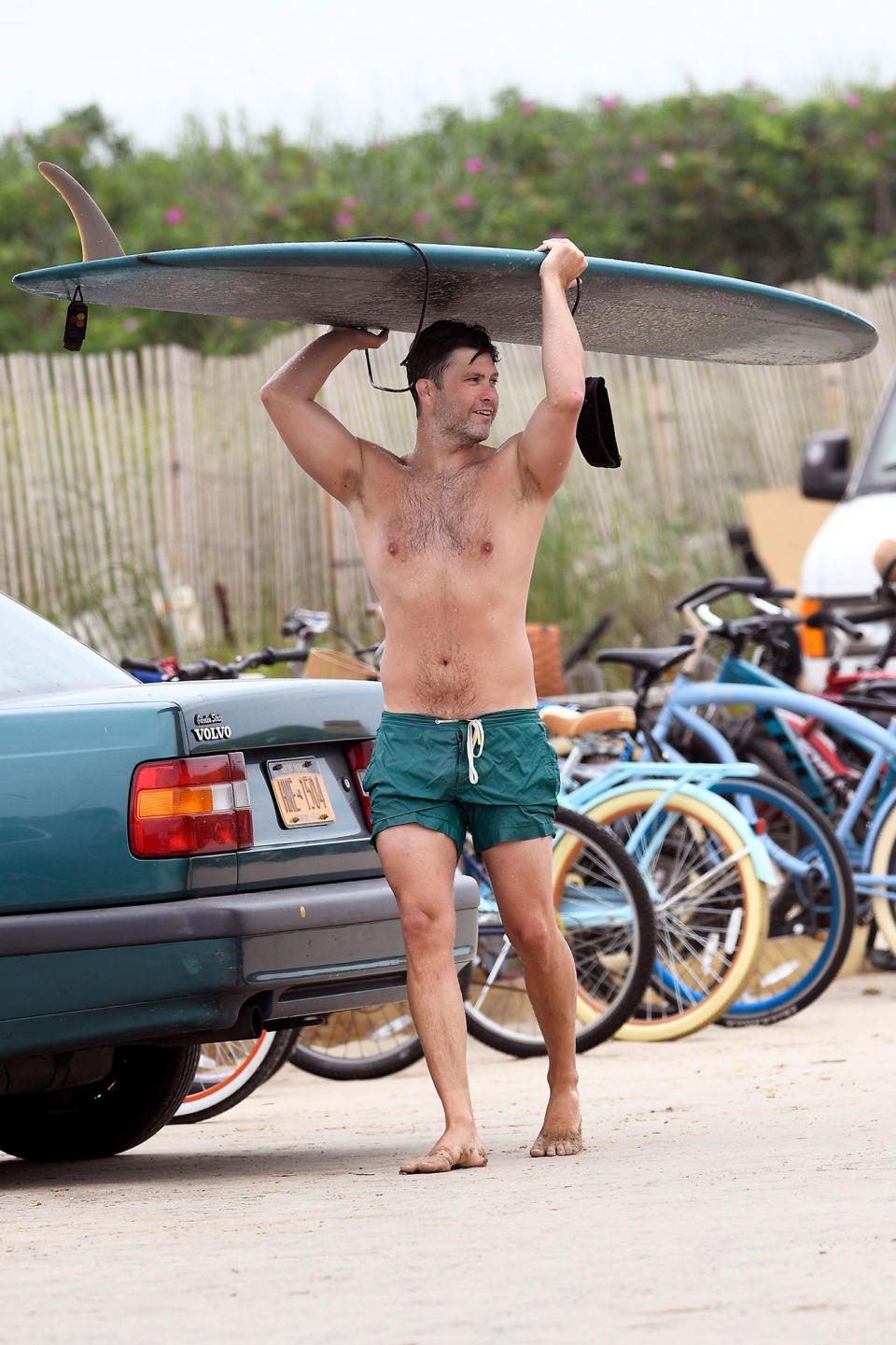 <p>A shirtless Colin Jost is spotted surfing with a friend in The Hamptons, New York, on Sunday.</p>