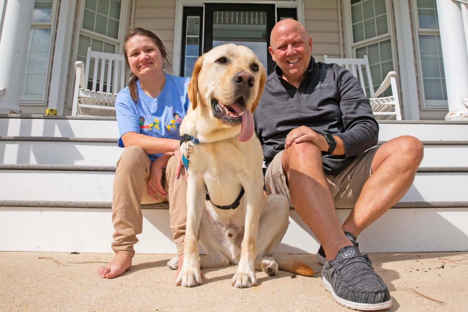 The Tinsley's, Jazmin and dad Kevin, along with Jazmin's new service dog, Bonus, sit on the front porch of the Tinsley family home in Rehoboth Beach, Wednesday, Sept. 27, 2023. Jazmin dreams of being a teacher and living independently one day.