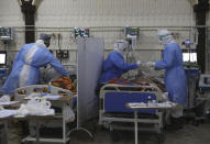 Nurses treat patients infected with the coronavirus in the intensive care unit at the Syrian American Medical Society Hospital, in the city of Idlib, northwest Syria, Monday, Sept. 20, 2021. Coronavirus cases are surging to the worst levels of the pandemic in Idlib province, a rebel stronghold in Syria — a particularly devastating development in a region where scores of hospitals have been bombed and that doctors and nurses have fled in droves during a decade of war. (AP Photo/Ghaith Alsayed)